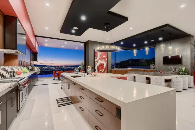 Remodeled kitchen with stone counters by LV Lux Construction
